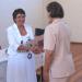 Berenice Daniels (Chief Education Specialist) presents a certificate to a teacher-mediator